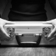 Close-up of a person holding a locked silver briefcase on a wooden table, symbolising secure cash courier services.