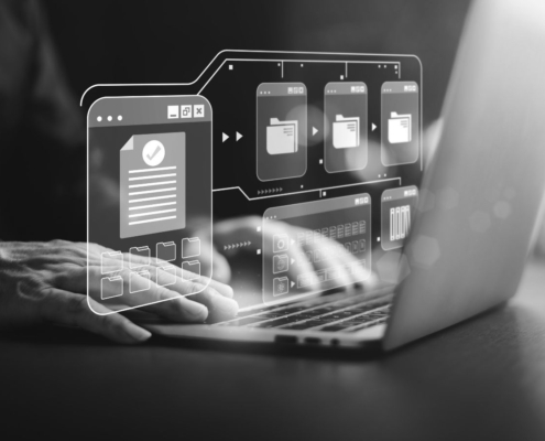 Person using a laptop with a digital access interface, representing security access control, user code management and access permissions.