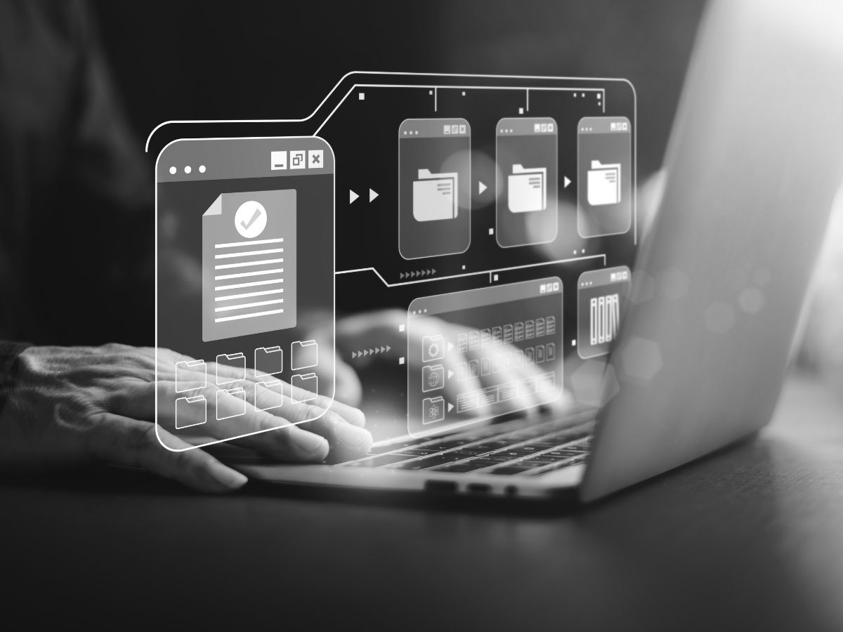 Person using a laptop with a digital access interface, representing security access control, user code management and access permissions.