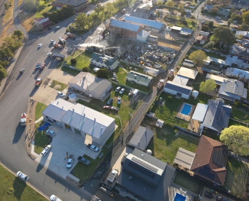 Aerial view of emergency services responding to a structure fire in a regional NSW town captured by PGC Aerial.