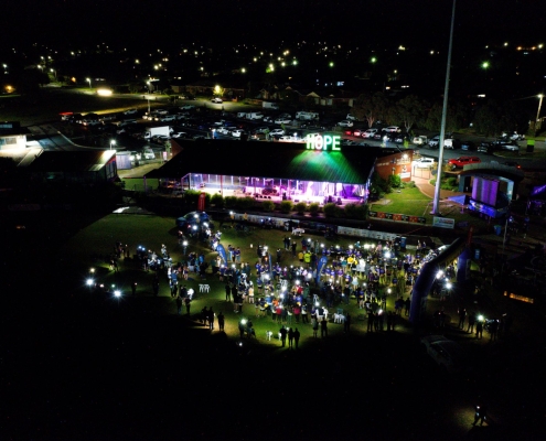 PGC Aerial Gallery image showing Relay For Life Albury Wodonga participants gathered at night under illuminated HOPE sign.