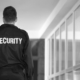 Security guard standing outside a commercial building during an after hours security patrol, monitoring and protecting business premises.