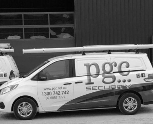 Three PGC Security vehicles parked outside a commercial building, representing mobile patrol and business security services.