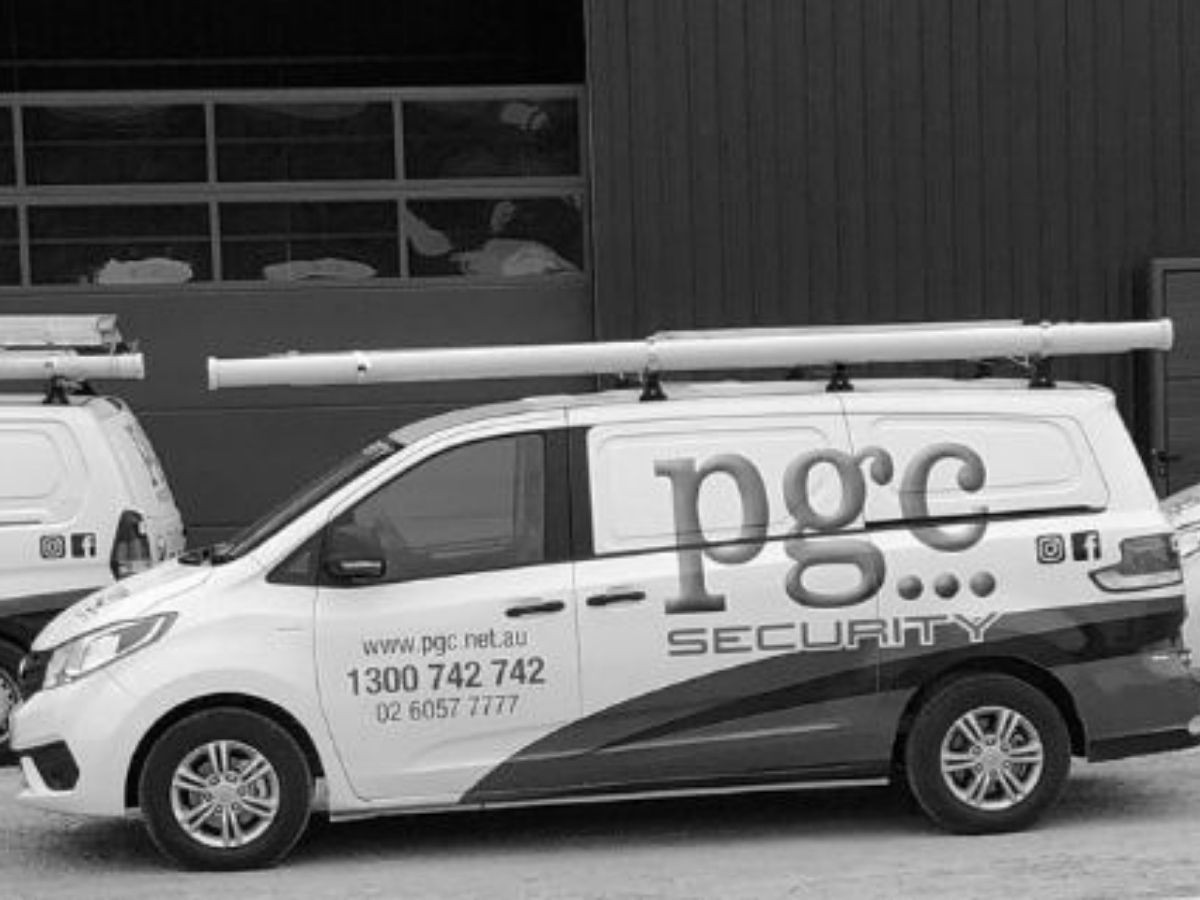 Three PGC Security vehicles parked outside a commercial building, representing mobile patrol and business security services.